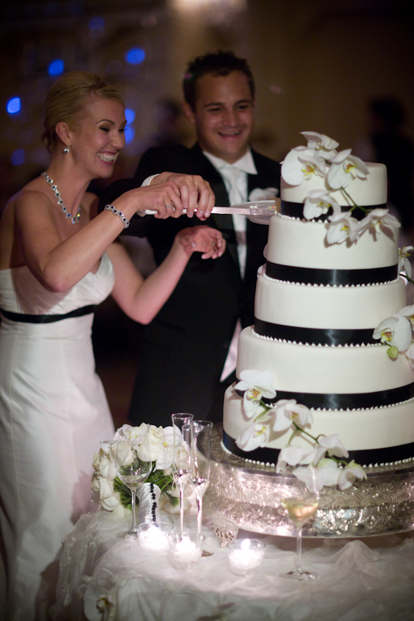 wedding photo by J Garner Photography, cake cutting, black and white wedding cake, the happy couple